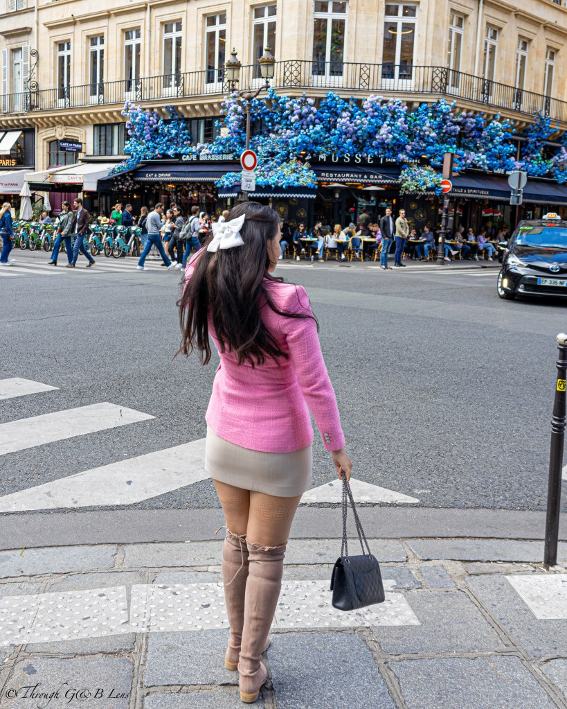 I would describe this style as preppy chic with a nodge to 2000's high school & academic aesthetics. This outfit is ultra feminine with the short skirt, thigh high boots, jewellery and pink blazer. To me this definitely gives Elle Woods in Legally Blonde vibes, or as an outfit Regina Georgia in Mean girls would wear. 